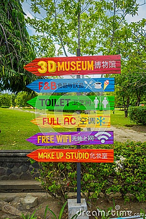 BALI, INDONESIA - MARCH 08, 2017: Informative sign in colorful arrows in a traditional balinese hindu temple Bajra Editorial Stock Photo