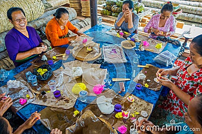 BALI, INDONESIA - MARCH 08, 2017: Women preparing an Indian Sadhu dough for chapati on Manmandir ghat on the banks of Editorial Stock Photo