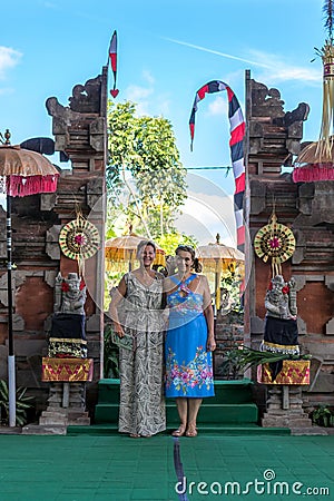 BALI, INDONESIA - MAY 5, 2017: European women near the traditional Balinese pura temple. Bali, Indonesia. Editorial Stock Photo