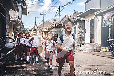 BALI, INDONESIA - MAY 23, 2018: Group of balinese schoolboys in a school uniform on the street in the village. Editorial Stock Photo