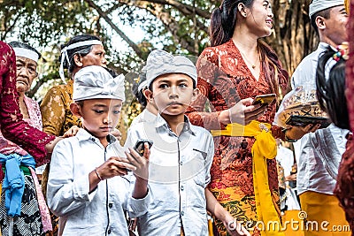 BALI, INDONESIA - SEPTEMBER 25, 2018: Balinese children in traditional clothes on a big ceremony in Tirta Empul Temple. Editorial Stock Photo