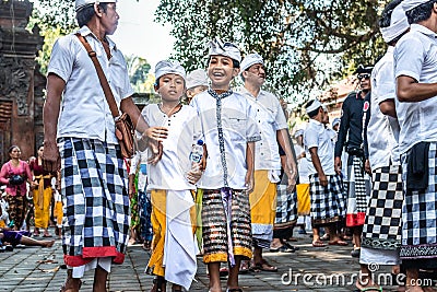 BALI, INDONESIA - SEPTEMBER 25, 2018: Balinese children in traditional clothes on a big ceremony in Tirta Empul Temple. Editorial Stock Photo