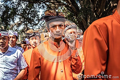 BALI, INDONESIA - SEPTEMBER 25, 2018: Balinese men in traditional clothes on a big ceremony in Tirta Empul Temple. Editorial Stock Photo