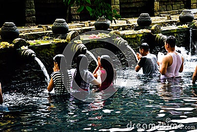 Balinese family taking a bath with holy water a sacred temple Editorial Stock Photo