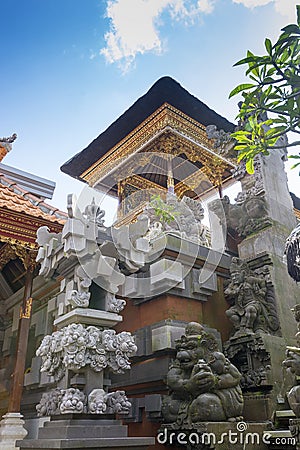 Balinese Hindu family shrine or temple ornately covered with gold showing many effigies of gods and demons. Stock Photo