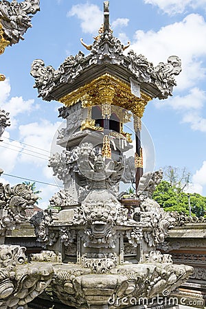 Balinese Hindu family shrine or temple ornately covered with gold showing many effigies of gods and demons. Stock Photo