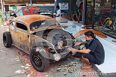 Balinese man renews old car Editorial Stock Photo