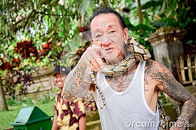 Balinese man and the snake show Editorial Stock Photo