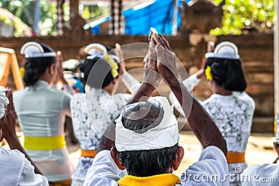 Balinese people praying on a traditional ceremony. Bali island. Editorial Stock Photo