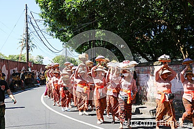 Balinese woman bringing funeral offerings. Editorial Stock Photo