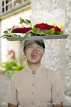 Balinese woman carrying tray on head Editorial Stock Photo