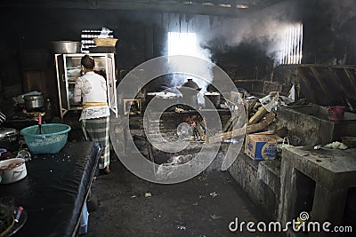 Balinese woman cooking in traditional kitchen Editorial Stock Photo