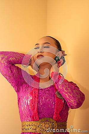 Balinese woman feeling sexy while wearing dress called Kebaya from Indonesia Stock Photo