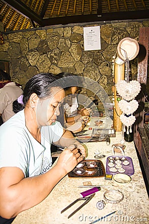 Balinese woman worker making silver jewellery in a traditional method in a Assamese jewellery manufacturing unit Editorial Stock Photo
