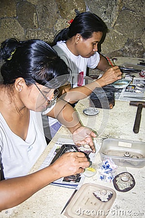 Balinese woman worker making silver jewellery in a traditional method in a Assamese jewellery manufacturing unit Editorial Stock Photo