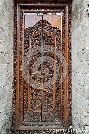 Balinese wood carved doors with traditional local ornaments Stock Photo