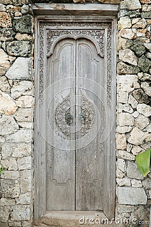 Balinese wood carved doors with traditional local ornaments Stock Photo