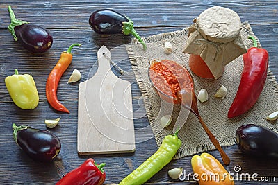 Balkan cuisine. Ajvar, delicious product of pepper, eggplants, garlic - on rustic table Stock Photo