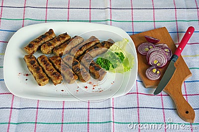 Balkan cuisine. Cevapi - grilled dish of minced meat Stock Photo