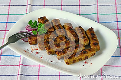 Balkan cuisine. Cevapi - grilled dish of minced meat Stock Photo