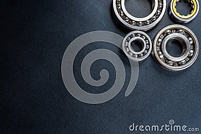 Ball bearing lying on a black background, flat view from above. Stock Photo