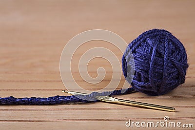 Ball of blue yarn with crochet needle Stock Photo