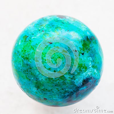 ball from Chrysocolla gemstone on white marble Stock Photo