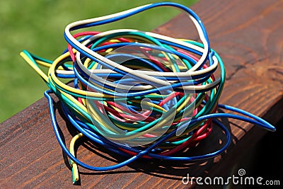 A ball of colored wires on a brown board. Soft focus. Stock Photo