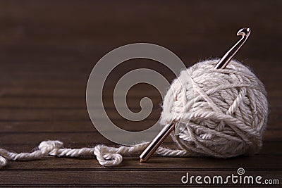 Ball of cream yarn with crochet hook Stock Photo
