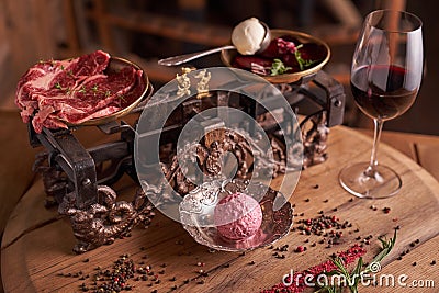A ball of ice cream from beets and meat in an old ice-cream bowl on the background of steaks seasoned beef on vintage scales Stock Photo