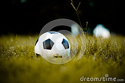 Ball on the lawn in a yellow field on the football field ready for punishment. And start actively football Stock Photo