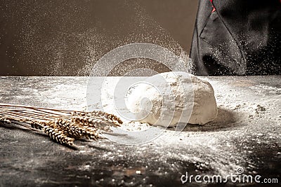 Ball of raw dough isolated on white wooden table with ears wheat. Copy space Stock Photo