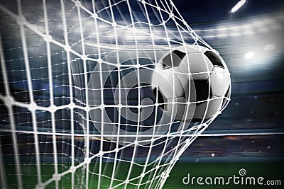 Soccer ball scores a goal on the net Stock Photo