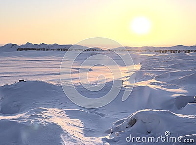 The setting sun over the winter plain Stock Photo