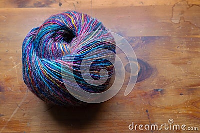 Ball skein of yarn in beautiful shades of blue, magenta, and yellow, needlework craft, theme, creative copy space Stock Photo