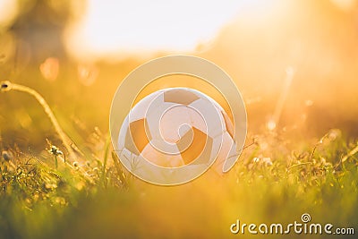 A ball for street soccer football under the sunset ray light. Film picture style. Stock Photo