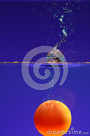Ball submerged in water Stock Photo