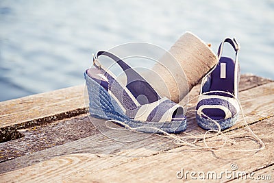 A ball of yarn around women sandals, shoes outdoors Stock Photo