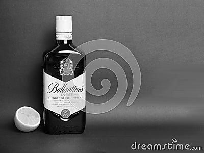 Ballantyne`s whiskey bottle and half lemon monochrome photo Editorial Stock Photo