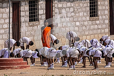 Teacher at Gymnastics at local primary school , Sanapur, Karnataka, India Editorial Stock Photo