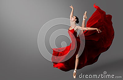 Ballerina Dance. Ballet Dancer in Red Dress jumping Spit. Woman in Ballerina Shoes dancing in Evening Silk Gown flying on Wind Stock Photo