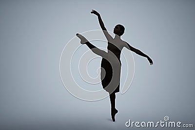 Beautiful ballerina dancing on light grey background, space for text. Dark silhouette of dancer Stock Photo