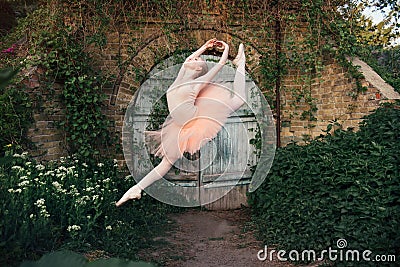 Ballerina dancing outdoors classic ballet poses in urban background Stock Photo