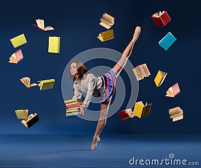 Ballerina in form of schoolgirl with pile books Stock Photo