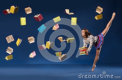 Ballerina in form of schoolgirl with pile books Stock Photo