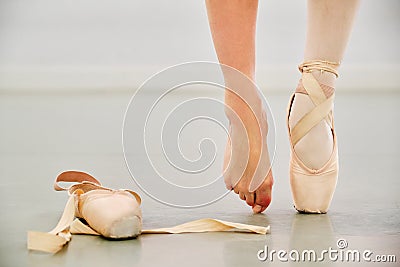 Ballerina legs wearing a pointe shoe on one foot and nothing on the other. Stock Photo