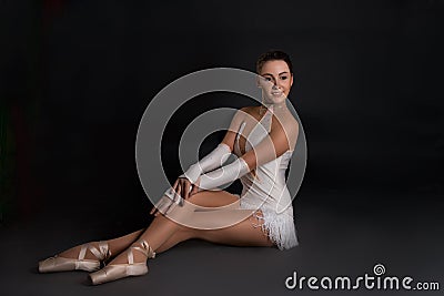 The ballerina sits and has a rest Stock Photo
