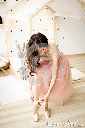 Ballerina tying pointe shoes Stock Photo