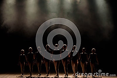 Ballet class on the stage of the theater with light and smoke. Children are engaged in classical exercise on stage. Stock Photo