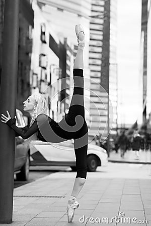 Ballet dancer show stretching on the city street. Stock Photo